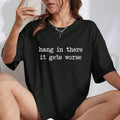 Hang In There It Gets Worse Tee – Funny Sarcastic Mental Health Humour Shirt by Teezioo