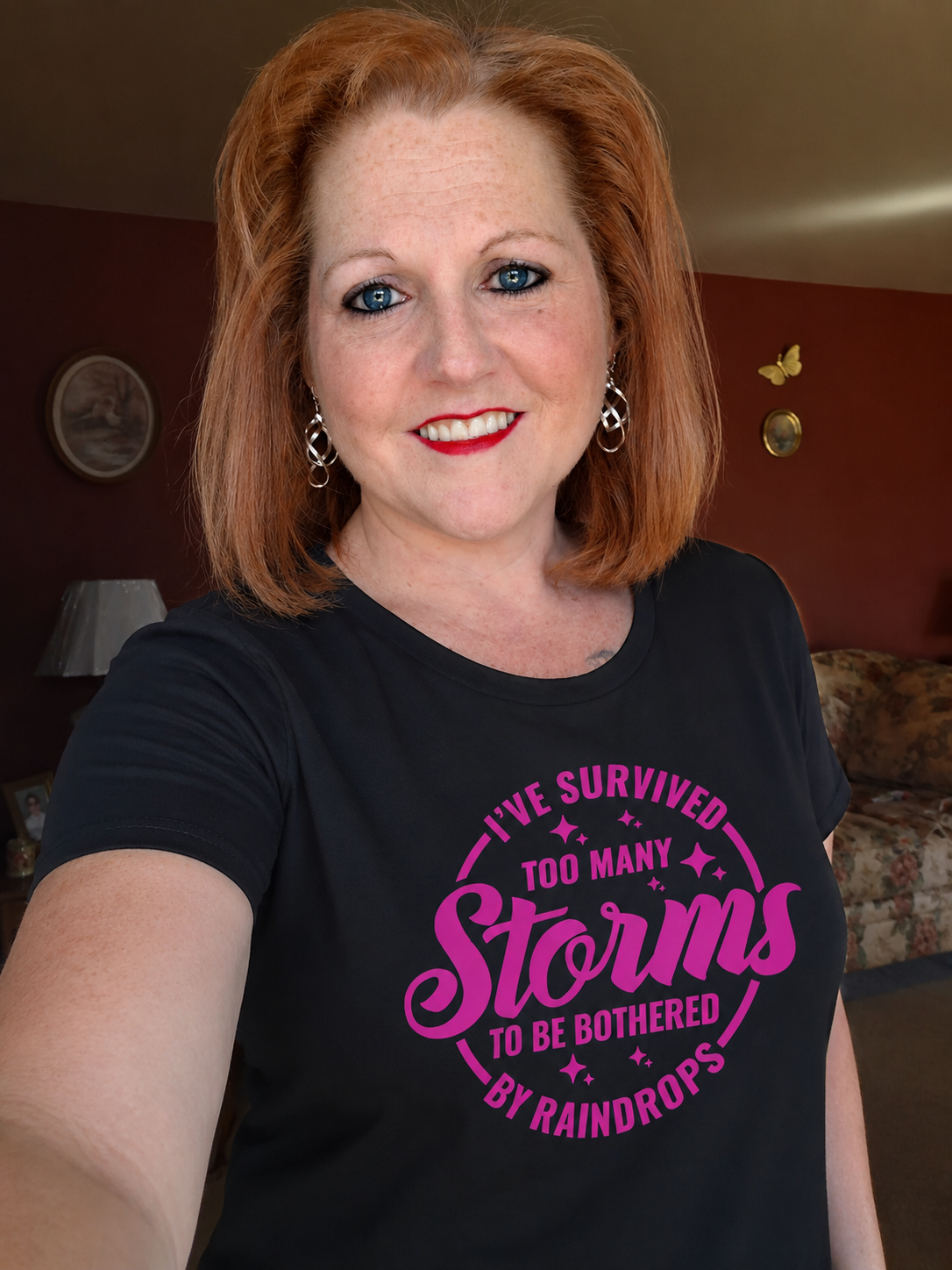Women's Tee — "I've Survived Too Many Storms to Be Bothered by Raindrops" Inspirational Pink Graphic by Printify